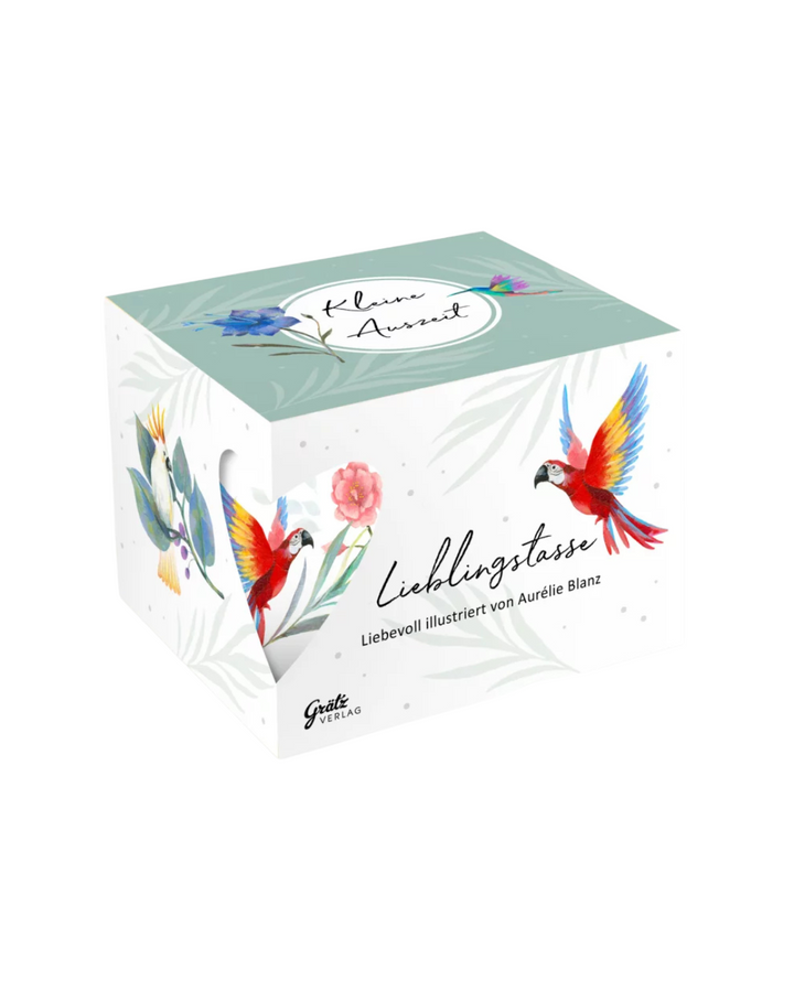 Geschenkverpackung mit der Paradiesvogel Lieblingstasse vom Grätz Verlag vor weißem Hintergrund. Auf dem Deckel steht: Kleine Auszeit.