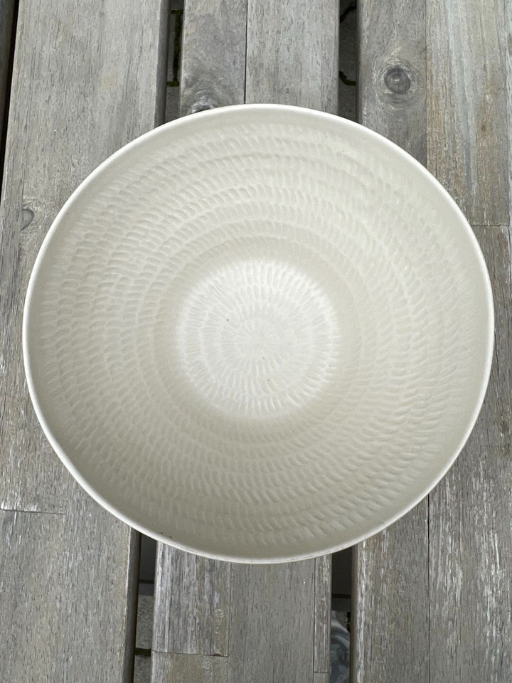 Ansicht von oben in die weiße Marseille Schüssel von Rivièra Maison auf einem Gartentisch.