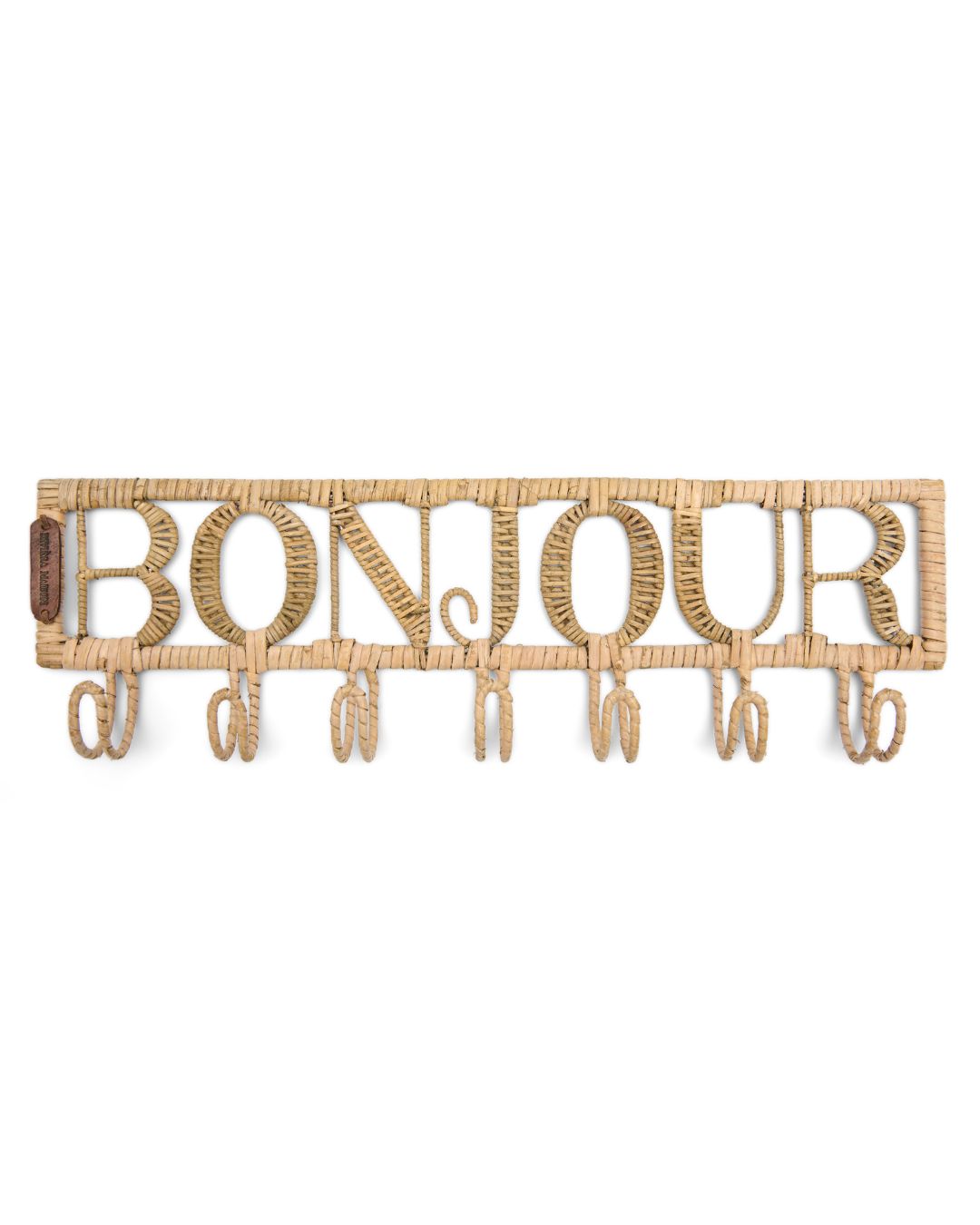 Diese Garderobe aus Rattan von Rivèra Maison besteht aus dem Schriftzug Bonjour und sieben Haken, die darunter angebracht sind.