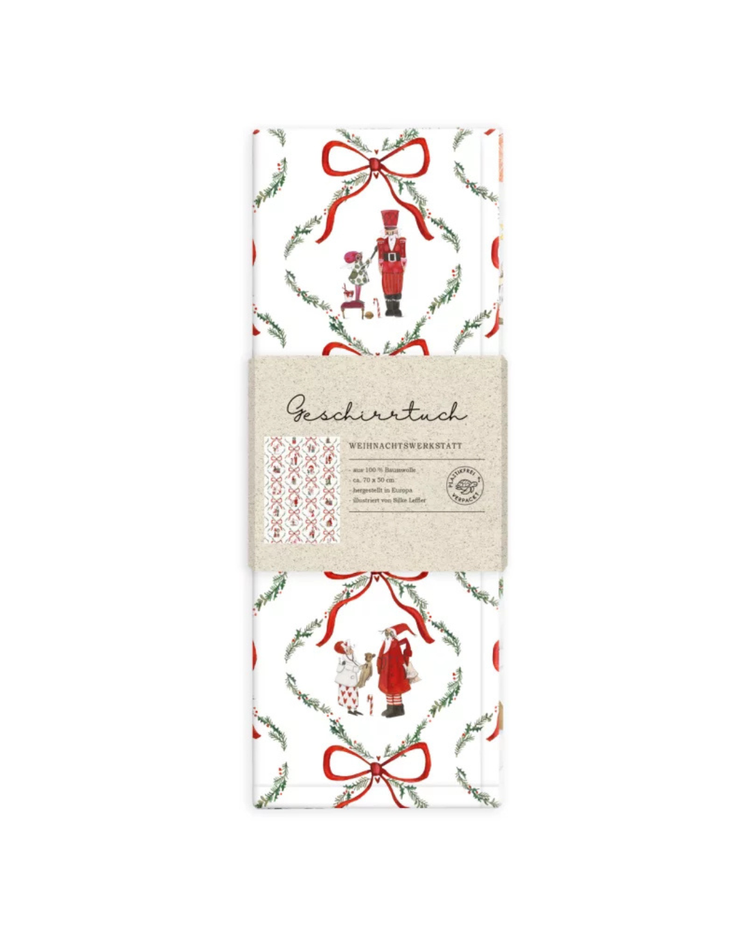 Verpacktes Geschirrtuch Weihnachtswerkstatt vom Grätz Verlag vor weißem Hintergrund. Die Vorderseite zeigt eine Detailansicht der Illustration von Silke Leffler mit Weihnachtsfiguren.