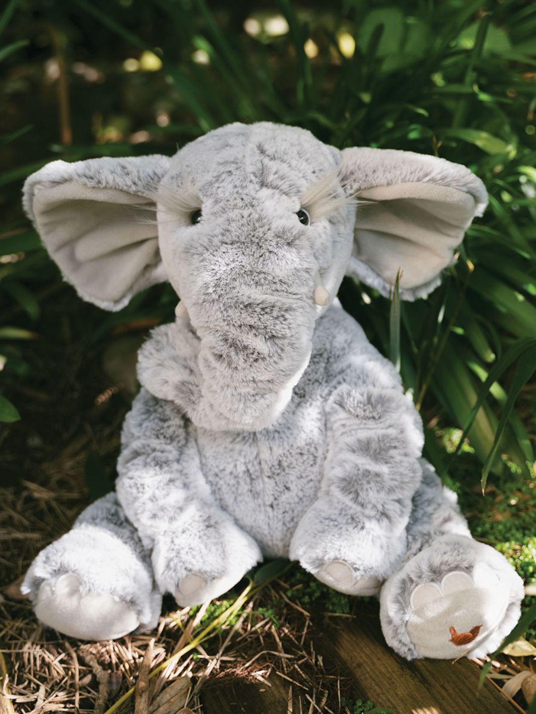 Super weiches Wrendale Designs Kuscheltier Winnie der Elefant sitzt im Wald.