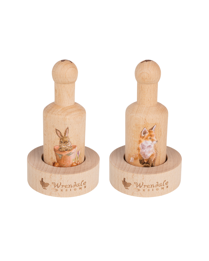 Zwei Anzuchttopf-Pressen von Wrendale Designs aus hellem Holz, eine mit Fuchs-Motiv und eine mit Hasen-Motiv, jeweils in passender Holzform stehend, freigestellt vor weißem Hintergrund.