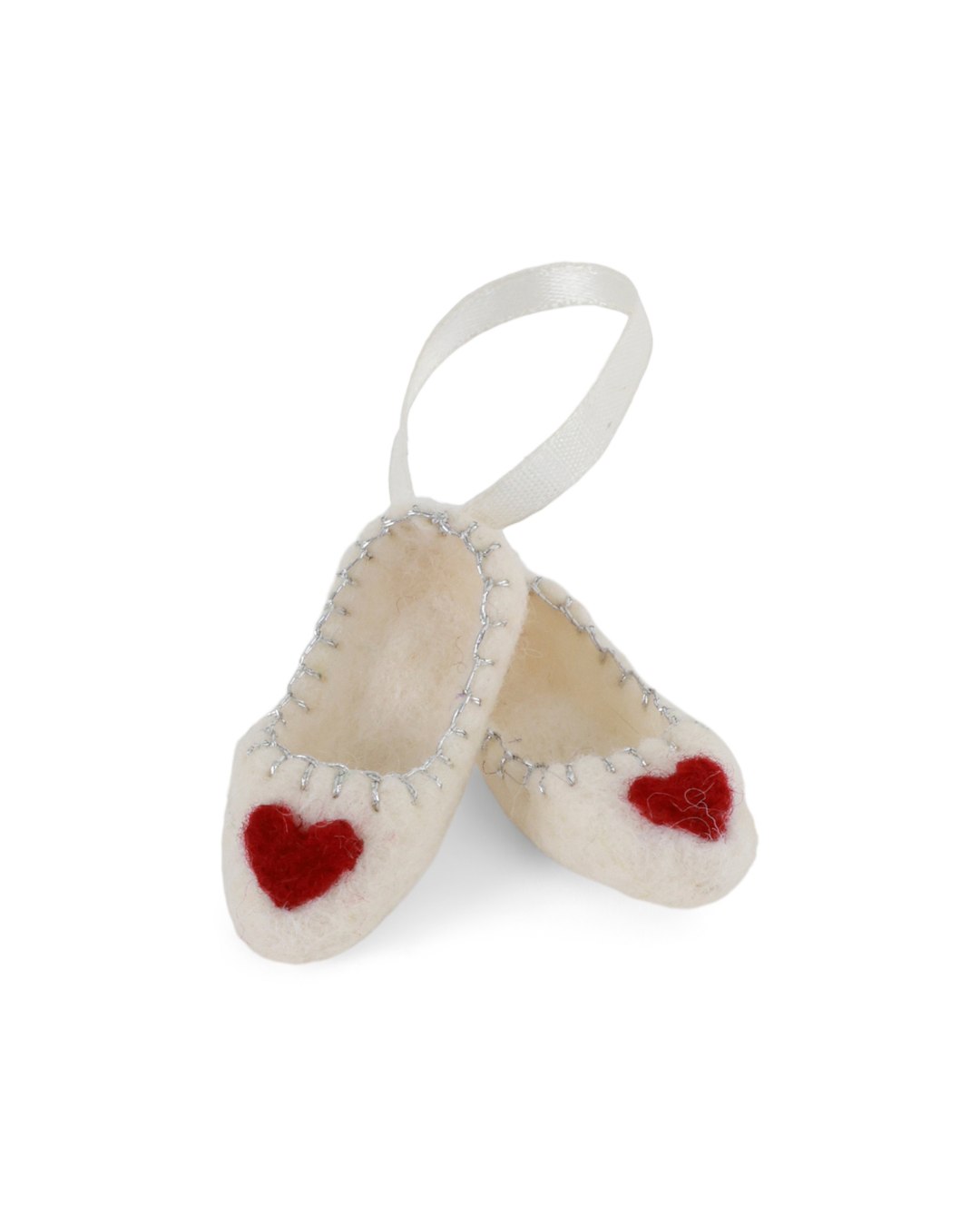 Filzanhänger "Ballerina Schuhe mit Herzchen weiß" von Gry & Sif. Die weißen Filzschühchen sind mit einem roten Herz auf der jeweiligen Schuhspitze versehen. der Saum am Einstieg der Ballerinas ist mit silbernem Garn verziert und die beiden Schuhe wurden mit einem weißen Bändchen verbunden.