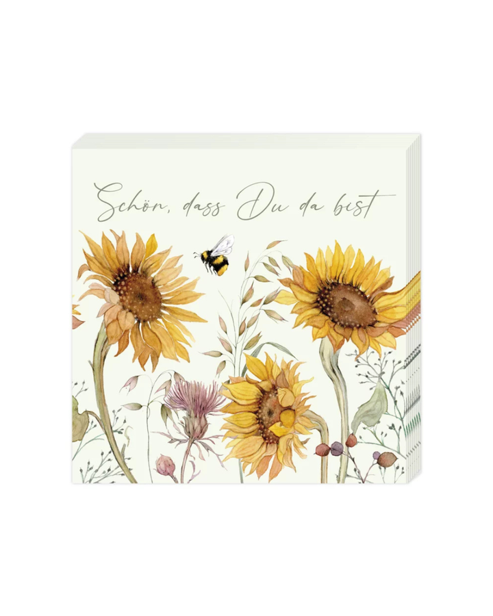 Die Verpackung der Cocktailservietten „Sonnenblumen“ vom Grätz Verlag. Zu sehen sind Sonnenblumen, Bienen und der Spruch „Schön, dass Du da bist“.
