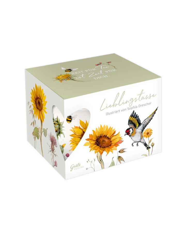Geschenkverpackung der Lieblingstasse mit Sonnenblumen Motiv vom Grätz Verlag vor weißem Hintergrund.