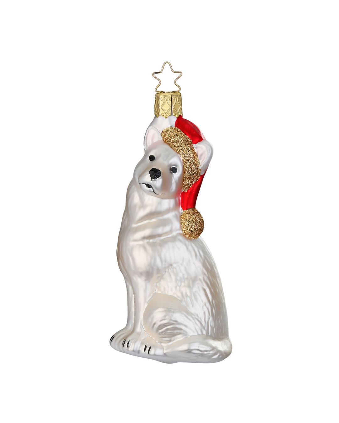 Hundeanhänger "Flocke" von Inge Glas hergestellt in deutscher Handarbeit. Ein sitzender Hund mit weißem Fell, roter Bommelmütze und goldenem Bommel.
