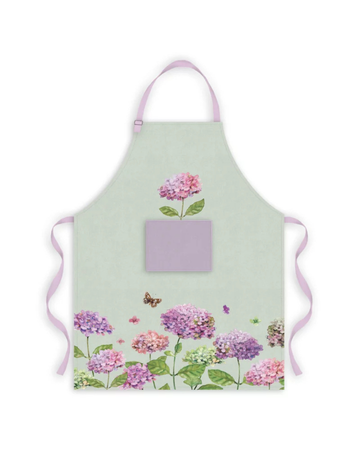 Kochschürze mit Hortensien-Motiv vom Grätz Verlag, Vorderansicht mit floralen Blüten in Rosa- und Lilatönen auf hellem Stoff