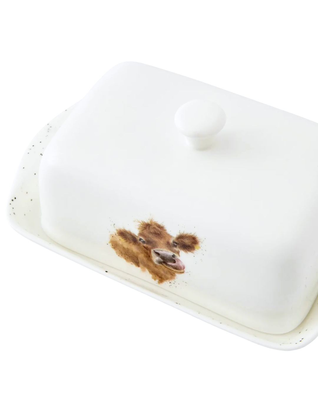 Obenansicht Kuh Butterdose "Royal Worchester" aus Porzellan von Wrendale Designs vor weißen Hintergrund.  Das Motiv zeigt eine Kuh mit herausgestreckter Zunge.