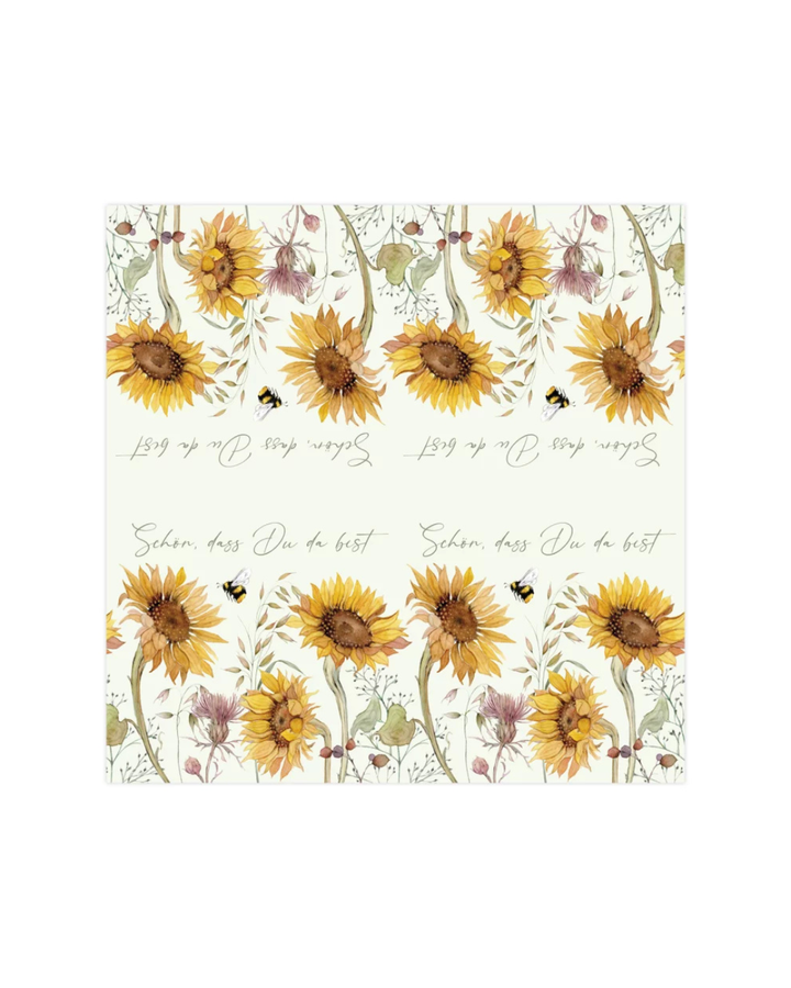 Die ausgebreiteten Cocktailservietten „Sonnenblumen“ vom Grätz Verlag. Das Muster zeigt Sonnenblumen, Bienen und den Spruch „Schön, dass Du da bist“ im Repeat.