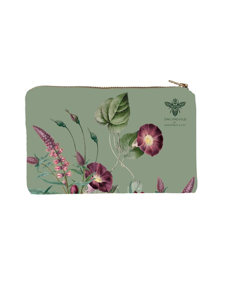 Kosmetiktasche mit Blumenmotiv und floralen Elementen auf grünem Untergund.