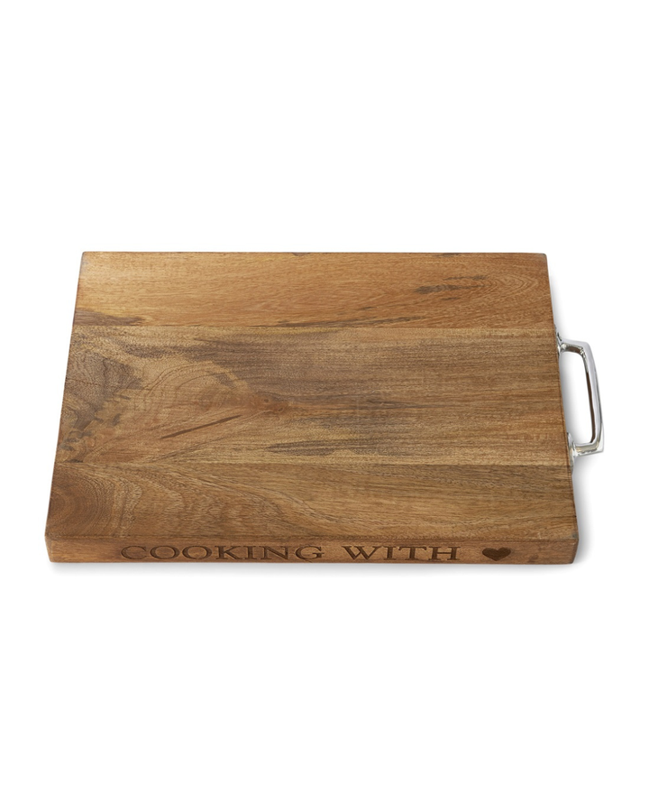 Schneidebrett „Cooking with Love“ von Rivièra Maison aus Holz, freigestellt vor weißem Hintergrund mit Griff und Schriftzug.