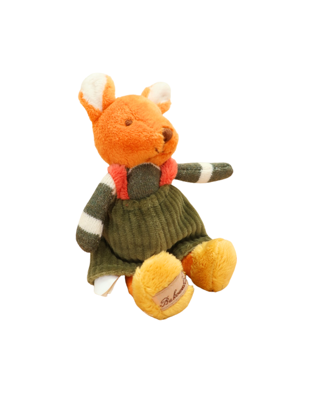 Das orangefarbene Stofftier-Kaninchen mit grünem Pullover sitzt seitlich auf weißem Hintergrund. Die Pfoten sind gelb, und es ist das Markenetikett „Bukowski“ zu sehen.