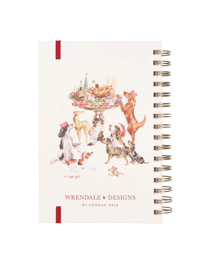 Rücksiete des weihnachtlichen Dackel Notizbuchs "Mistletoe and Barks" von Wrendale Designs. Verschiedenste Hunde begucken einen reichlich Gedeckten Weihnachtstisch.